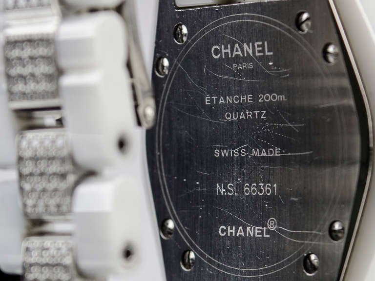 Make a bold statement with this stunning Chanel J12 series watch crafted from high-gloss Ceramic (highly scratch resistant). This watch features steel rimmed bezel set with 2-rows of VS Quality Top Wesselton white diamonds, all white ceramic