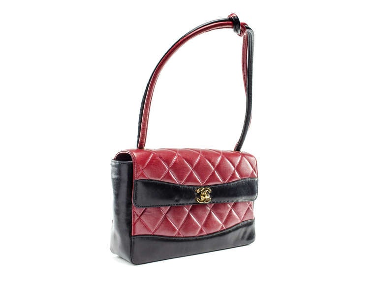 Make a statement in this eye-catching vintage Chanel bag! This bag features red & black lambskin leather throughout, gold hardware, flap detail, shoulder strap with knotted detail. Interior features one zippered pocket and one pouch pocket.
