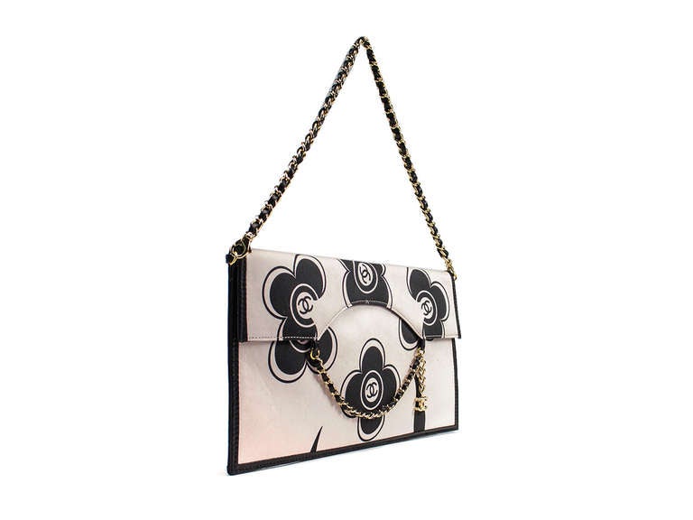 Wear this beauty as a clutch or a shoulder bag with the removable strap. Featured in white satin this back features black Camellia flowers printed throughout with iconic 'CC' logo at center, gold tone and black leather chain detail at front,