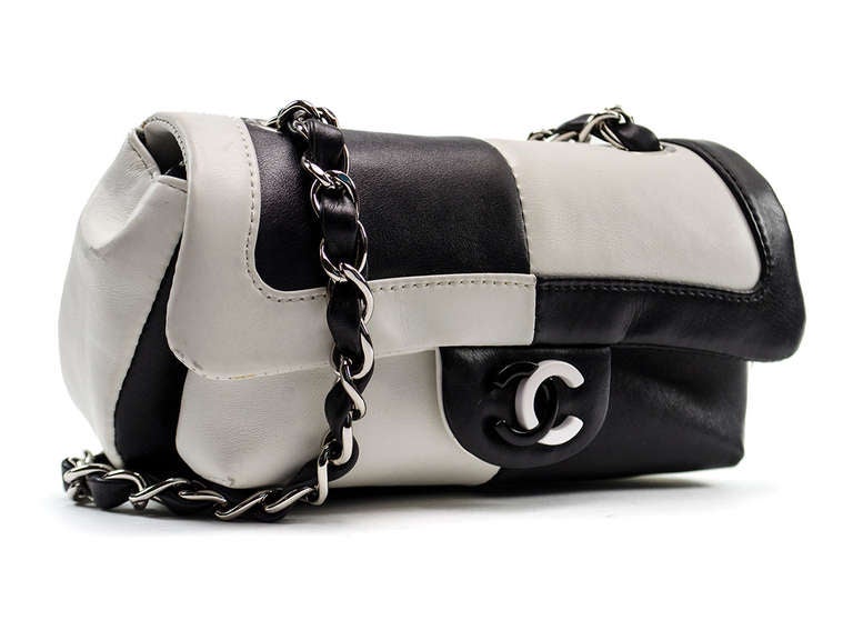 This rare Chanel Black/White Leather Colorblock Chain Flap Bag is truly a beautiful piece to collect. It features unique colorblock luxurious leather with the signature leather/chain strap and a resin CC logo. We can always count on Chanel to create