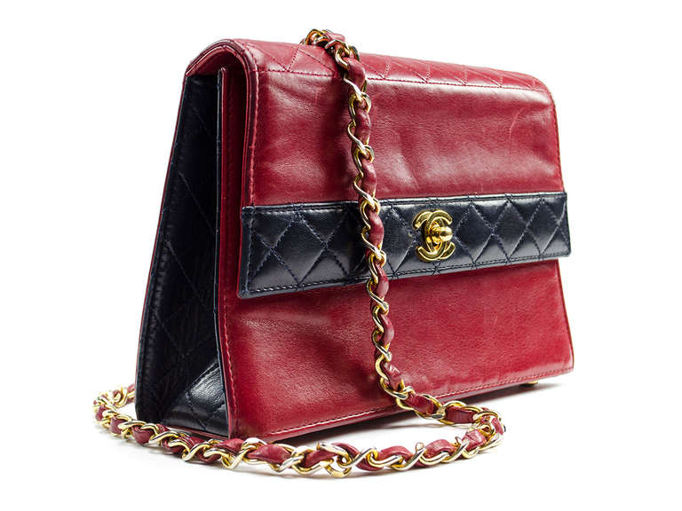 Be the epitome of lovely with a billowy blouse, cat eye sunglasses and the Chanel black and red color block bag. Slick leather structured bag features quilted red leather paneling on front, back and sides. A gold interlocking CC charm adorns the