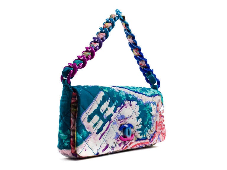 This durable and stylish creation by Chanel is something you will want to carry forever. The Chanel Multicolor Quilted Canvas Watercolor Pochette Flap Bag is part of Chanel's 2011 Cruise Collection and is perfect for warm weather travel. The