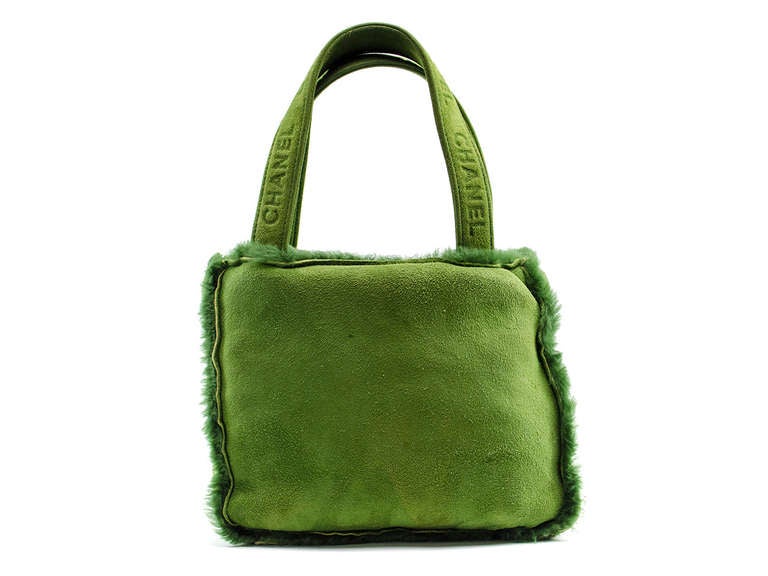 Take a stroll in the park with this fun loving Chanel suede mini green tote! Green suede throughout with shearling trim, suede top handles. Interior features two zippered pockets, one pouch pocket.