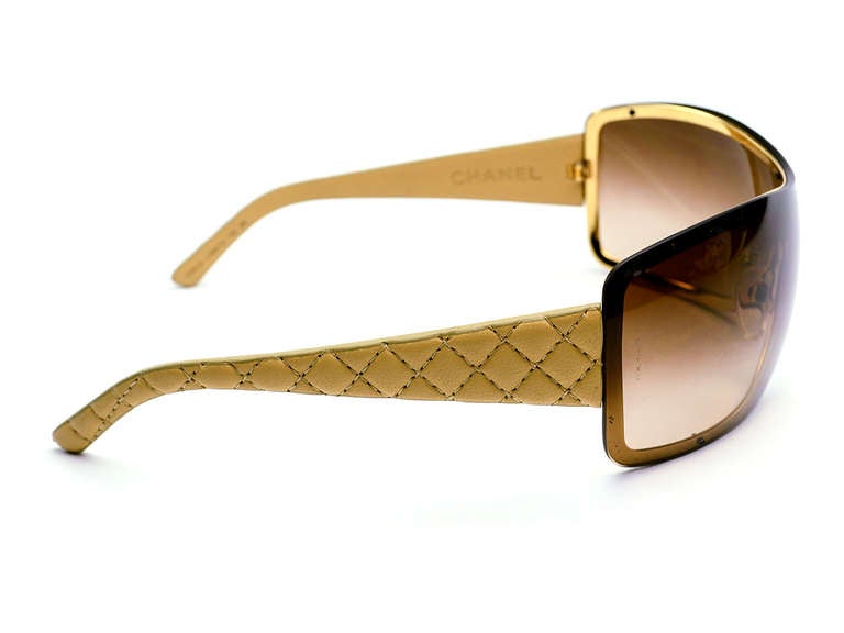 Make a subtle statement in these stunning Chanel sunglasses! These sunglasses feature quintessential diamond pattern, beige leather. Style 4155. C.369/13. 120 3N.

Includes: Box & Case.