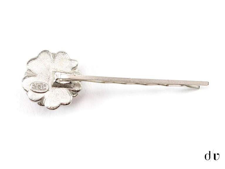 Absolutely adorable! Chanel silver tone hair pin with pink and silver tone camellia flower at the center.

Includes: Box.

Measurements: Approximately 2.5