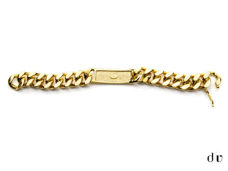 Make a statement in this Chanel ID bracelet. This bracelet is featured in gold tone hardware and reads the words 'CHANEL' written across the front. Note: The clasp is not in working condition and only slips on over the hand.

Measurements: Length