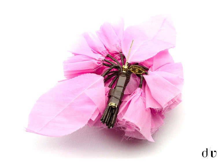 Make a statement in this eye catching Chanel ruffled floral brooch in baby pink! Brooch is constructed of pink silk. Retail price is $585.

Includes: Box.