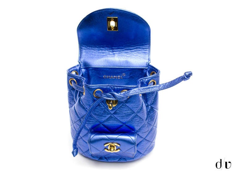 Head back to school in style or just out on the town in this ultra-rare Chanel metallic blue backpack! This backpack is featured in elusive blue metallic leather with gold tone hardware and one front pocket with gold tone interlocking 'CC' detail,