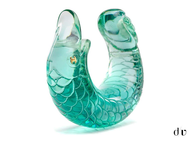Stand out from the crowd in this extremely rare Chanel fish cuff! This cuff is featured in teal of a Koi fish with interlocking gold 'CC' Chanel eyes. Note: The Chanel plaque is no longer attached.
Includes: Dust Bag.