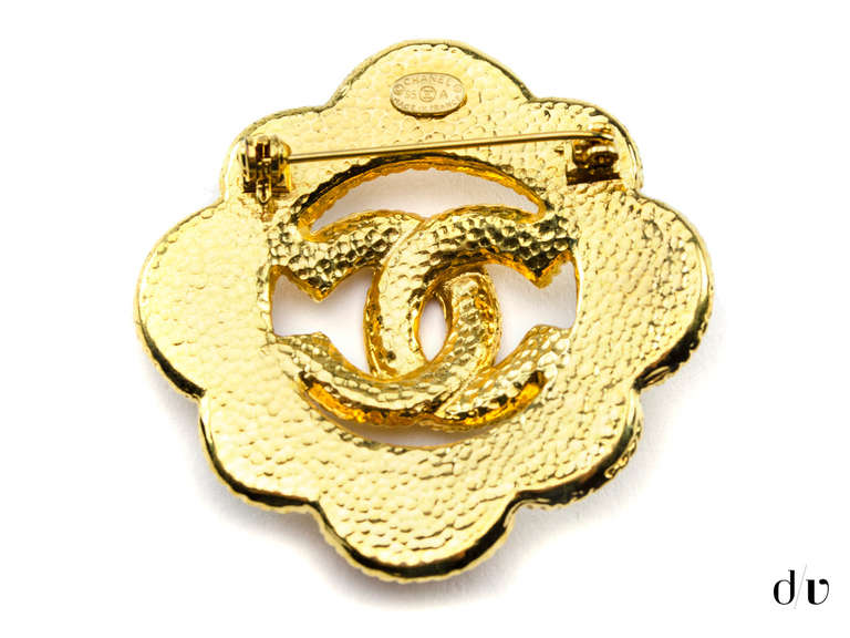 Extremely versatile! Chanel vintage brooch can be worn with a little black dress or just with a denim jacket! This brooch features interlocking 'CC' detail at the center with faux pearl detail and Swarovski crystal detail around the outside.