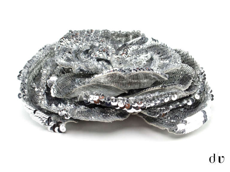 Stunning! Chanel sequin runway brooch in the traditional Camellia flower brooch. Grey sequins adorn this brooch throughout, pins at the back. Retail was $3975.

Includes: Box.

Measurements: 7