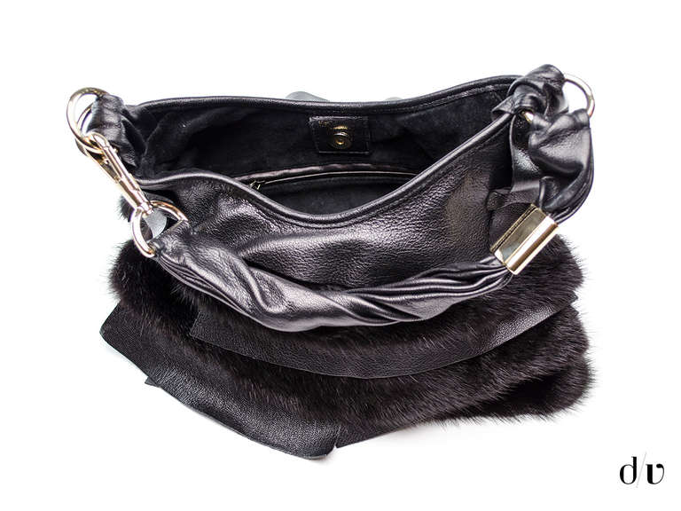 Make a statement in this extremely rare Yves Saint Laurent St.Tropez bag! Ideal for the Tom Ford collector as this was one of his great collections with YSL! This bag features black leather ruffle detail throughout with overlapping black fur detail.