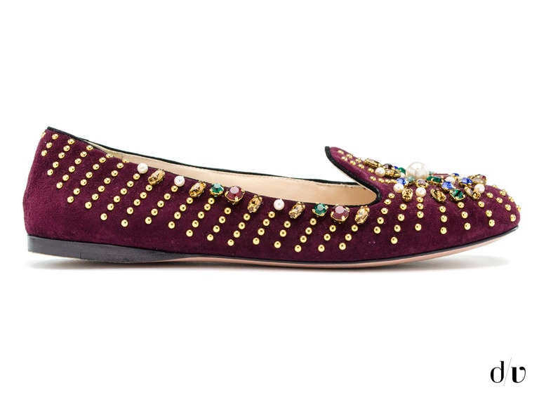 Classic suede smoking slipper with studs and jewel embellishments.

Suede upper with metal studs, rhinestones and faux pearls
Leather lining
Leather and rubber sole
Padded insole
Made in Italy