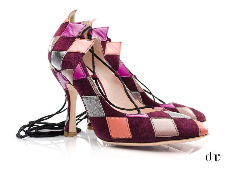 Miu Miu brings this very fun and unique heel. Chevron stitching pattern accented with contrasting leather patches against the burgundy suede base. Round toe and black lace up ankle strap finish the look. Leather outsole. Heel measures 4.5