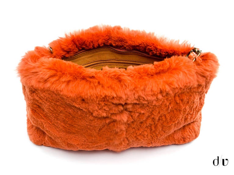 Be the trend setter you are with this super unique fur Chanel shoulder bag. It is covered in extremely soft orange fur, and has a leather with dark metal strap. Includes an authentication card with purchase. 

Dimensions: 11