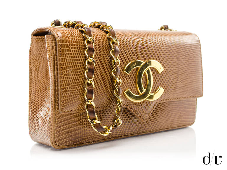 Perfect update to the classic Chanel bag, this vintage lizard flap will sure to have you standing out from the crowd! Featured in brown lizard with gold tone hardware throughout. Interior features one pouch pocket. Made in France.

Includes: Dust