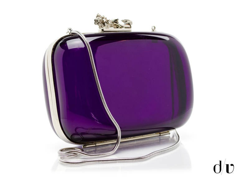 On trend! Vintage lucite box bag is done in a beautiful purple with silver tone hardware detail with a hand holding a floral arrangement as the closure.