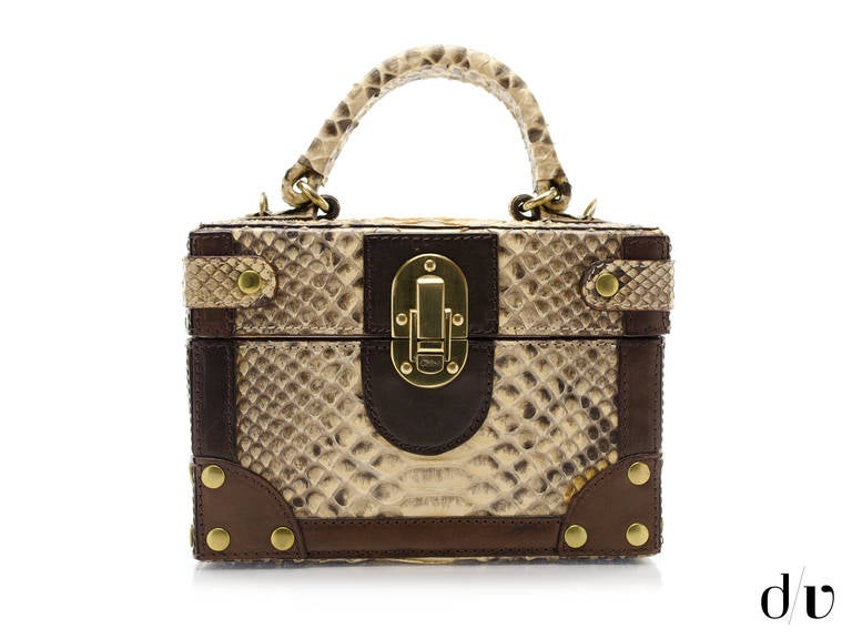 Never can find a chic carry all for your beauty goodies? Fear no longer as Chloe has answered your beauty traveling woe's with this chic vanity in python. Opens up inside to a top mirror and expandable side pocket detailing throughout. Made in