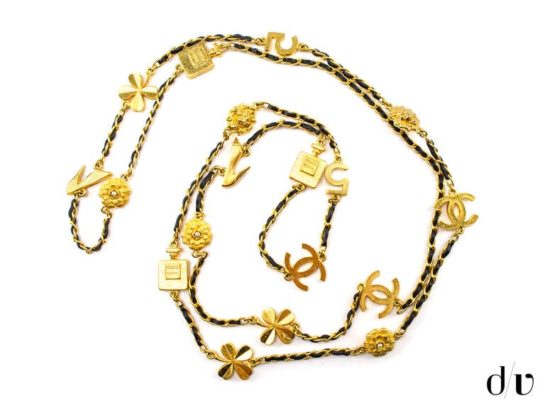 This necklace features iconic motif charms: clovers, shoes, number 5, lioness with faux pearl, Coco perfume bottles. Complements very well other Chanel pieces or can be worn alone as a signature piece bearing all the famous selective styles of