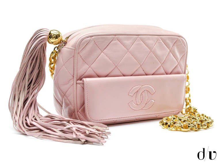 Take this vintage Chanel bag for a stroll on a Sunday afternoon! This bag is featured in pink lambskin leather, gold tone hardware, diamond quintessential pattern throughout, exterior features one button pocket. Interior features one zippered