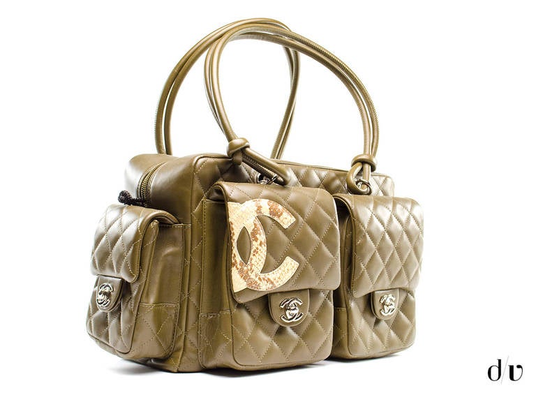 This bag will be sure to carry your everyday essentials! Featured in olive green lambskin leather with python details throughout, the iconic interlocking 'CC' logo is set at the edge of the bag, two front pockets, two side pockets and one back pouch