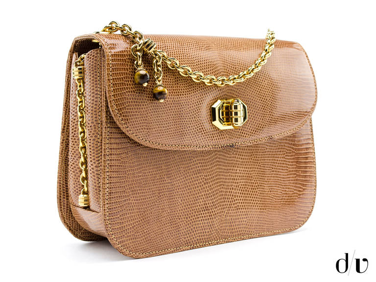 The lizard shoulder bag is extremely stylish and striking. The hip interior makes the bag an interesting accessory, especially when paired with a little black dress and high heels. There is ample space to keep your stuffs inside the flap