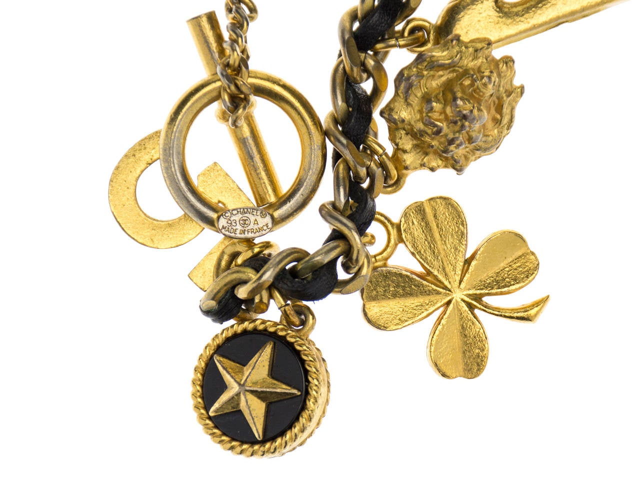 his is one of our favorite pieces from 1993 that incorporates signature chain and leather design by Chanel. Selection of charms include camellia flower with the pearl center, leo head, perfume bottle, clover leaf and number five to mention few. Bar