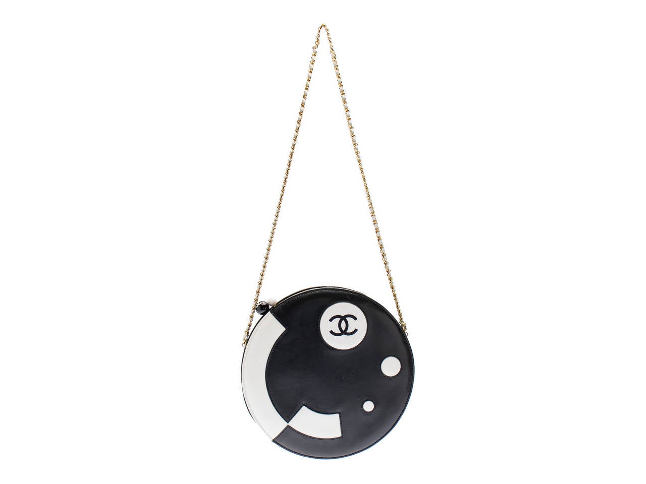 Extremely rare! Chanel ying yang bag is featured in black and white with a Japanese like feel with two white circles on the front as well as the iconic Chanel logo. Kiss lock closure in black and white resin. Can be carried as a clutch or shoulder