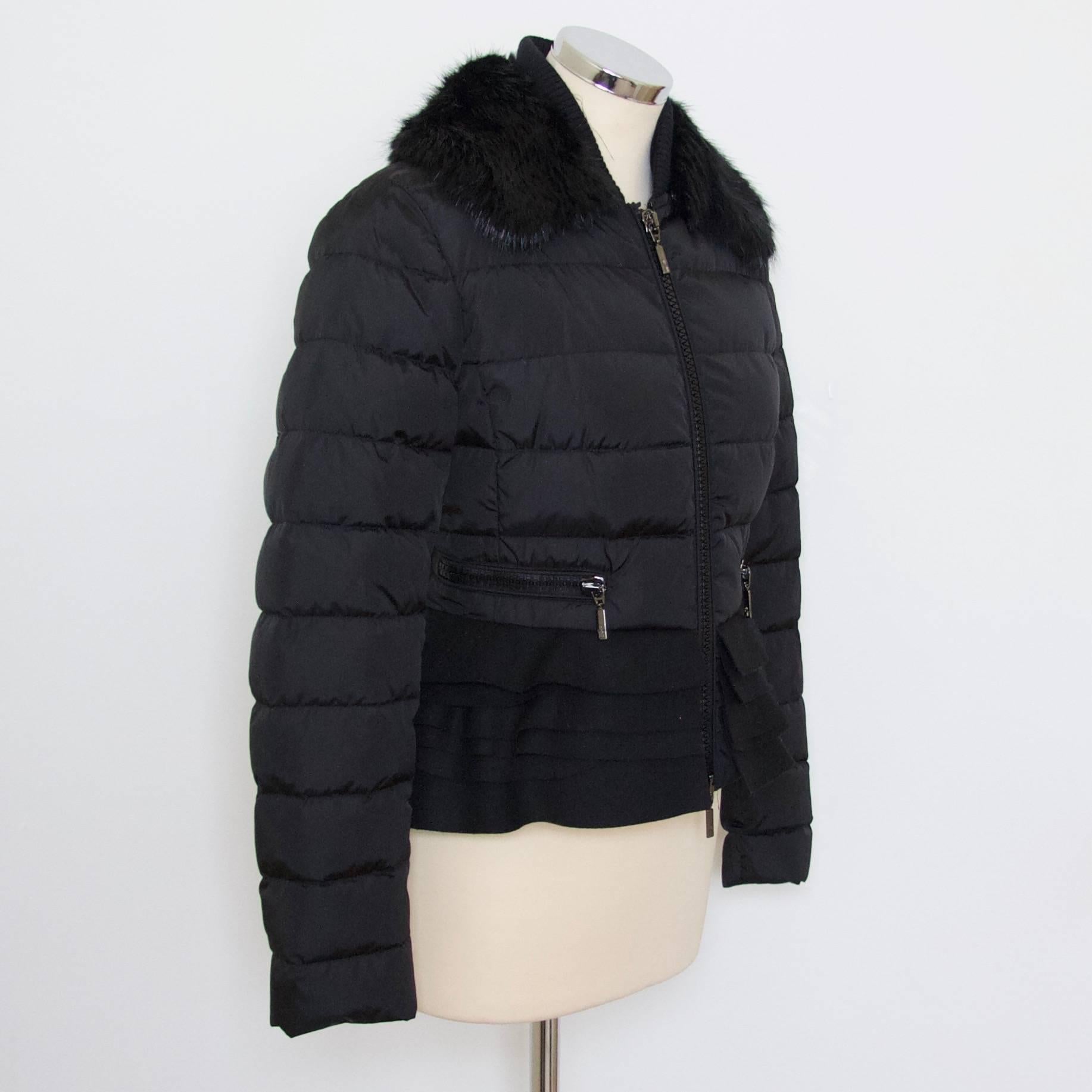 Moncler black ski jacket with detachable black beaver collar.

Also features a felted peplum waist detail.  