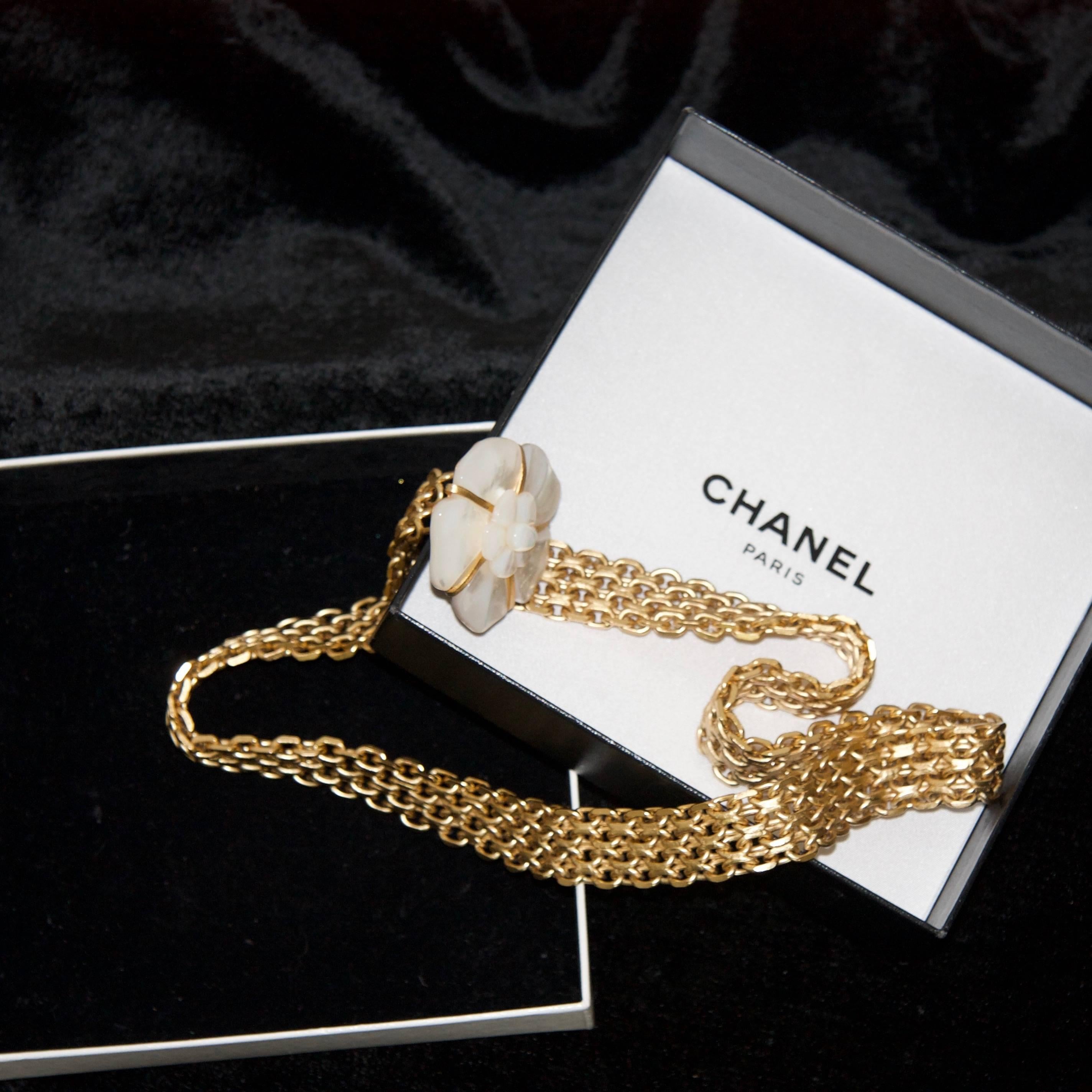 2001 Chanel gold plated camellia waist/hip belt.
Camellia flower made with mother of pearl mounted on a filigree plate.