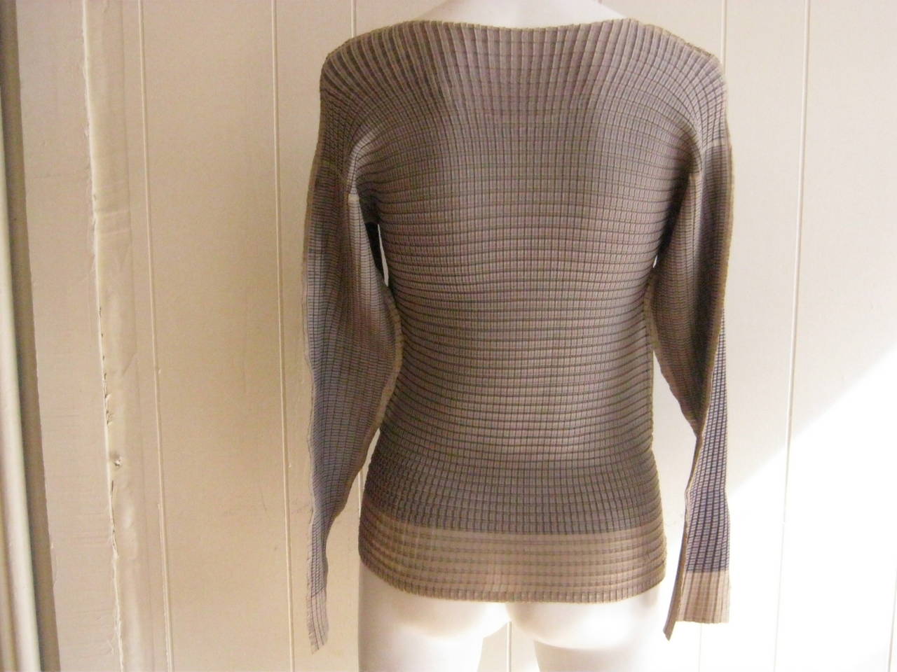 Amazing top by Issey Miyake in a polyester ribbed pattern, it has a scoop neck and wonderful dolman sleeves. There is stretch in the material.