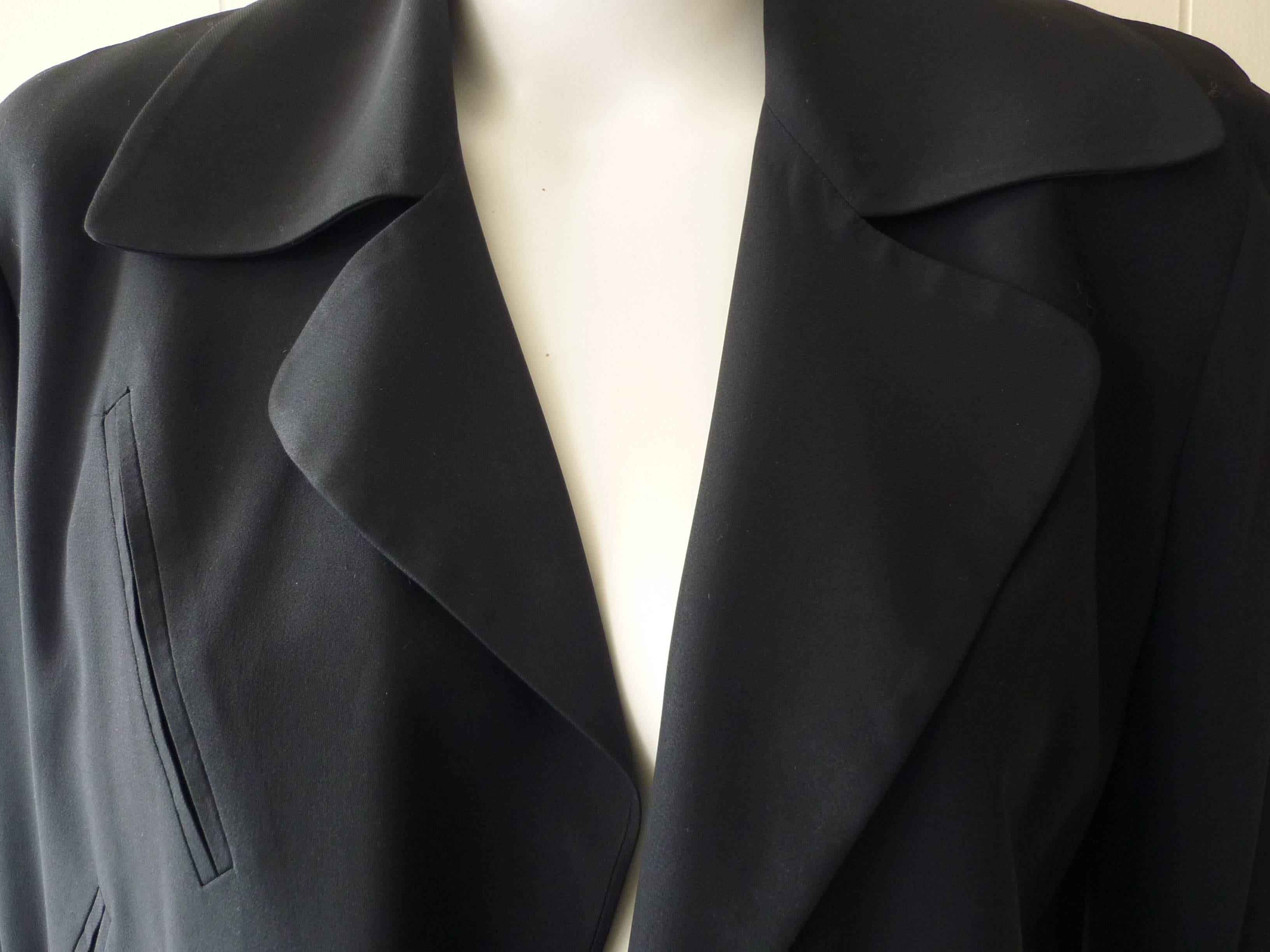 Nice details such as uneven lapels; and assortiment of flap and slit false pockets; slit on sleeves, and no closure, it is a very easy jacket to wear.

The materials are 50/50 rayon and acetate.