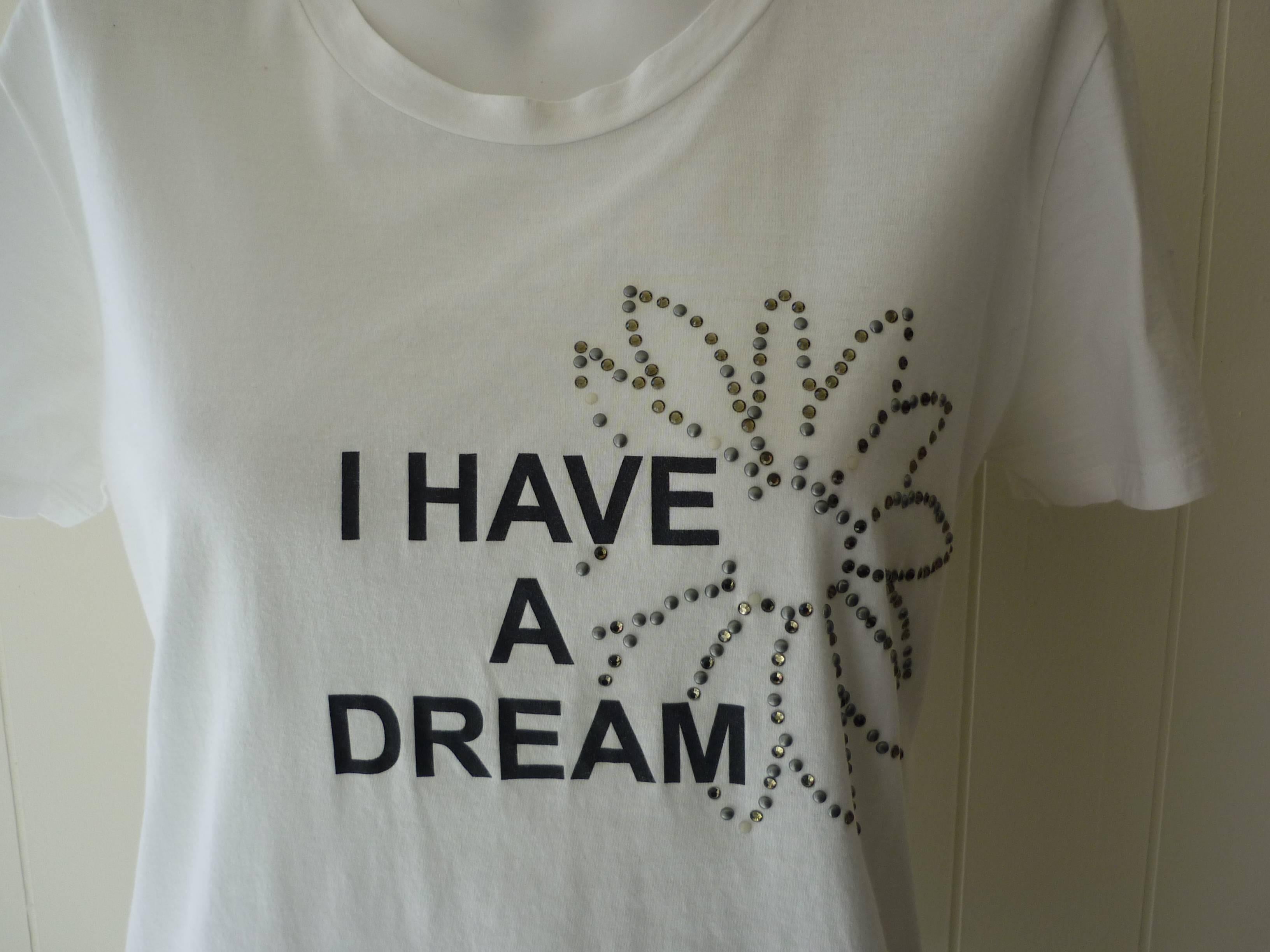 This is one of a series of messages for the S/S 2009 Collection Anniversaire which also promoted Obama and the Democratic Party. The Quote is of course from Martin Luther King.

The t-shirt is made in France of 100% cotton and studded in the form