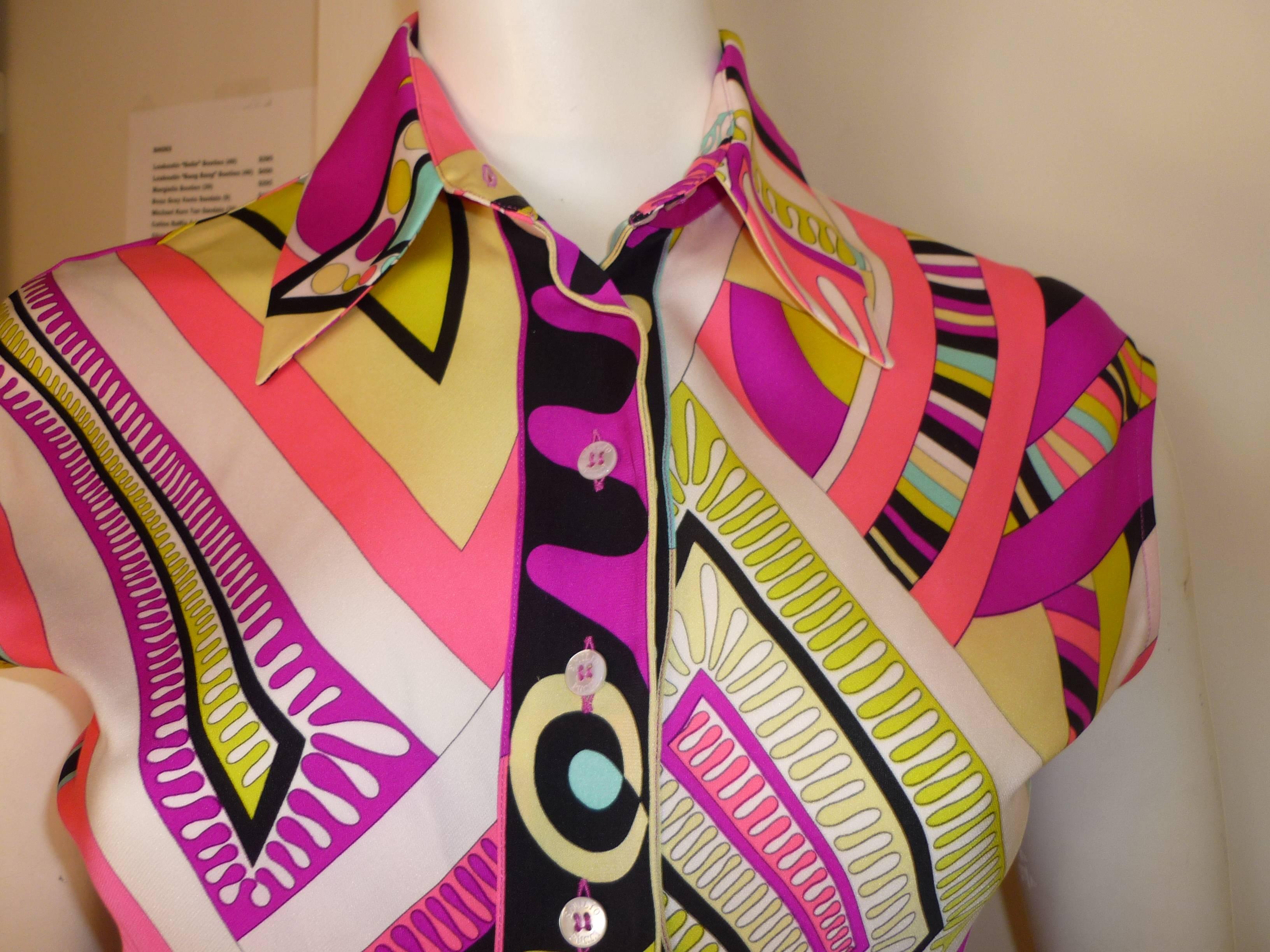 The colors are magnificient and almost have a 3D look. This silk blouse is blouson at the waist; is shorter at the front; as beautifully stitched button holes, and the buttons are engraved with the design house name, 

As in all Pucci items the