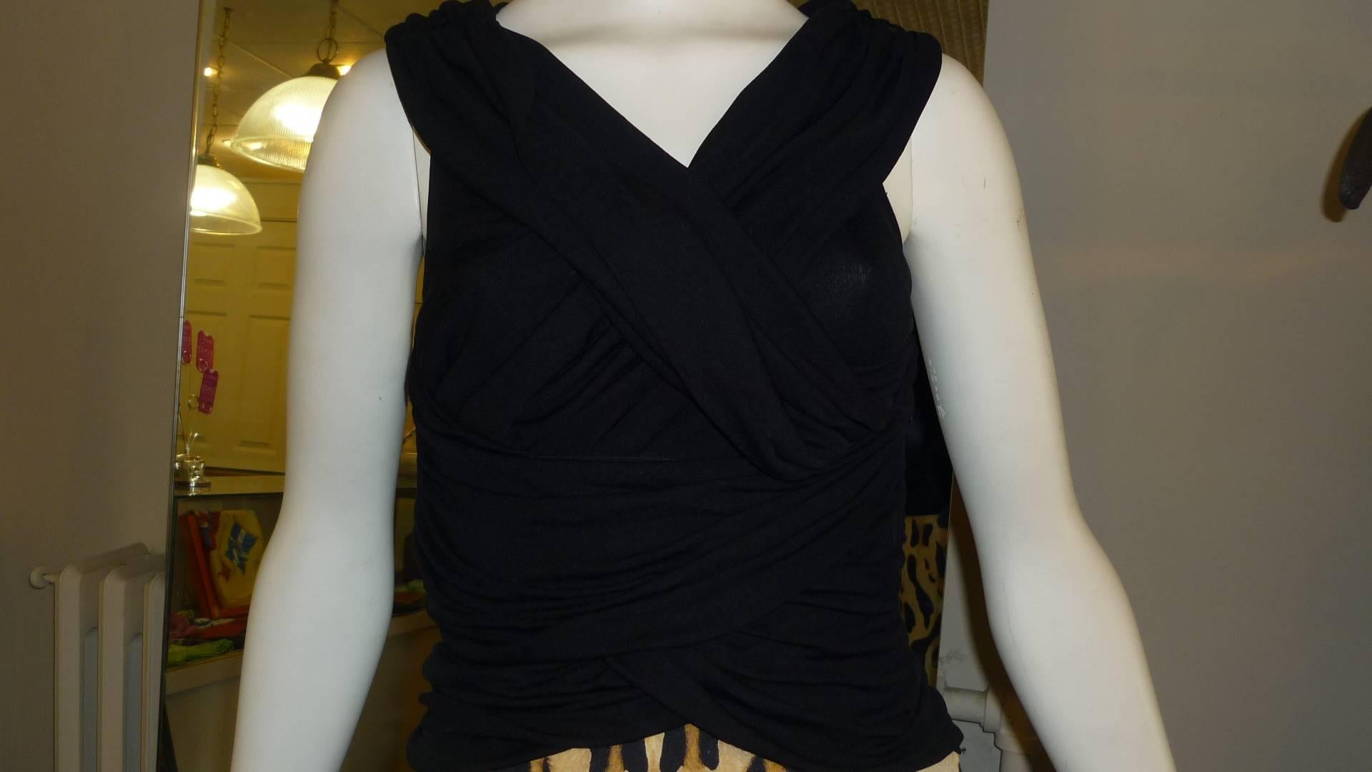 This two-tone dress has a black top made of silk and polyamid with elasthane with a lot of draping, giving the effect of a cowl neckline and gathered bust and waist. The wide gathered straps are adjustable.

The bottom is made of raw silk with a