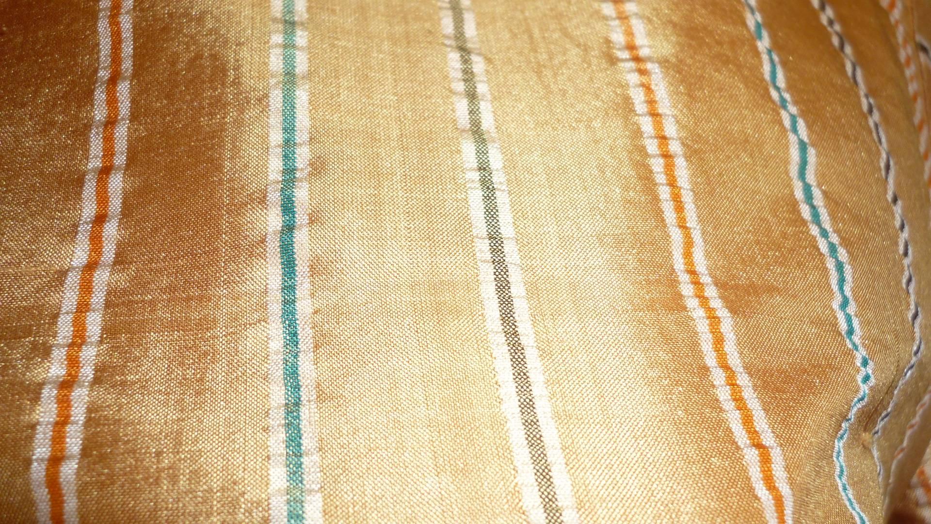 Vey nice fitted raw silk shirt with a golden bronze background and multicolored stripes.