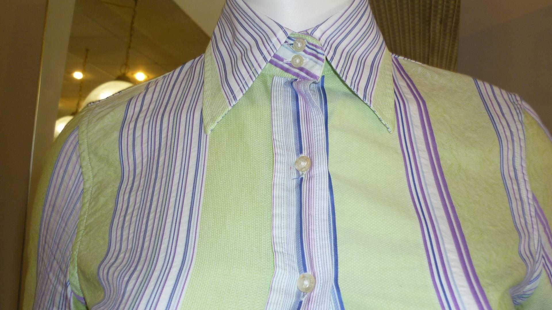 A mix of blue, purple, white and blue stripes as well as a green lace effect.  This is a beautiful shirt which can be dressed up or down.