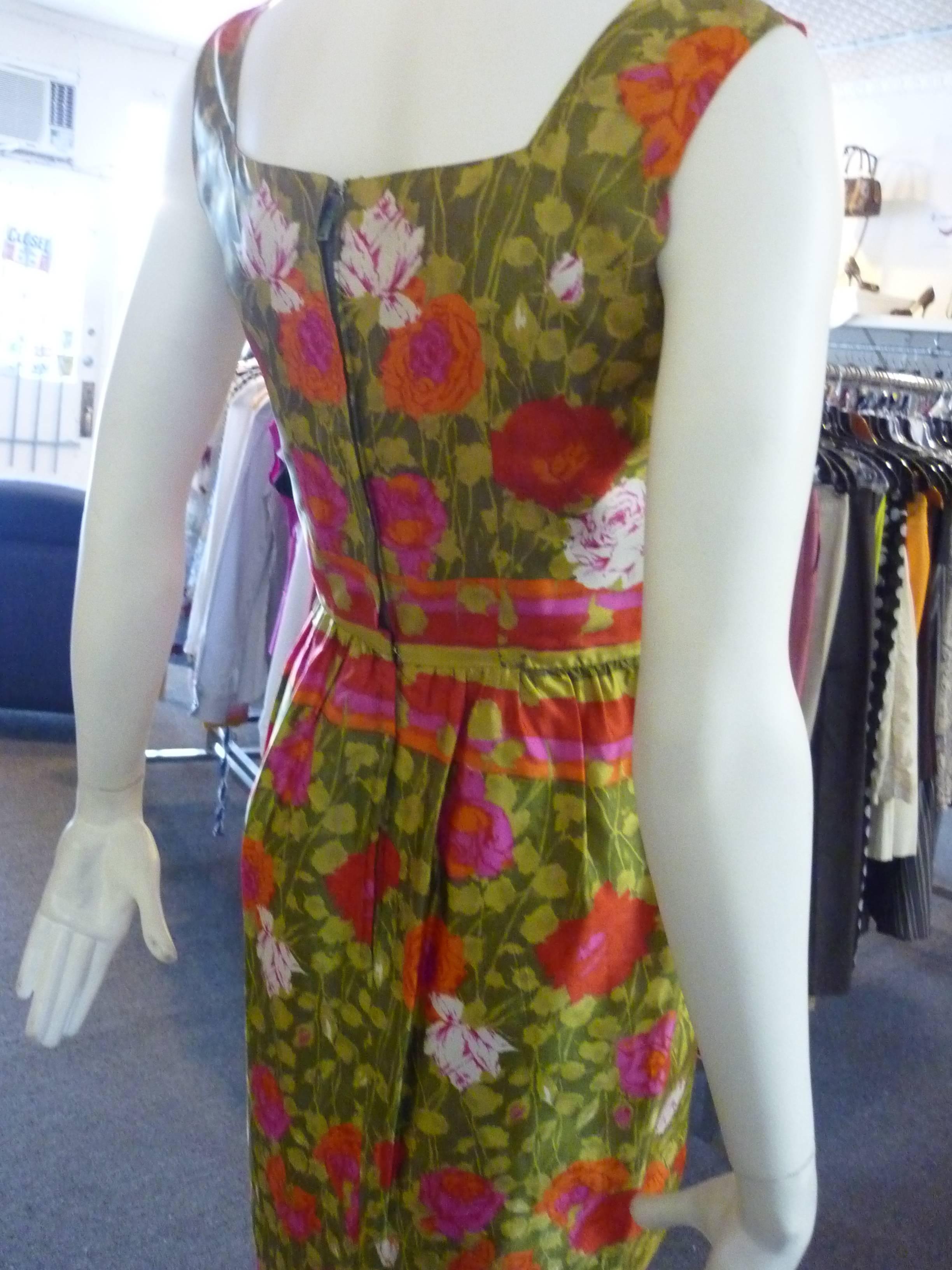 Beautiful silk in a floral print with side bust pleats; defined waist and hidden zip. Jeannette Alexander is the daughter of the designer Peggy Hunt.