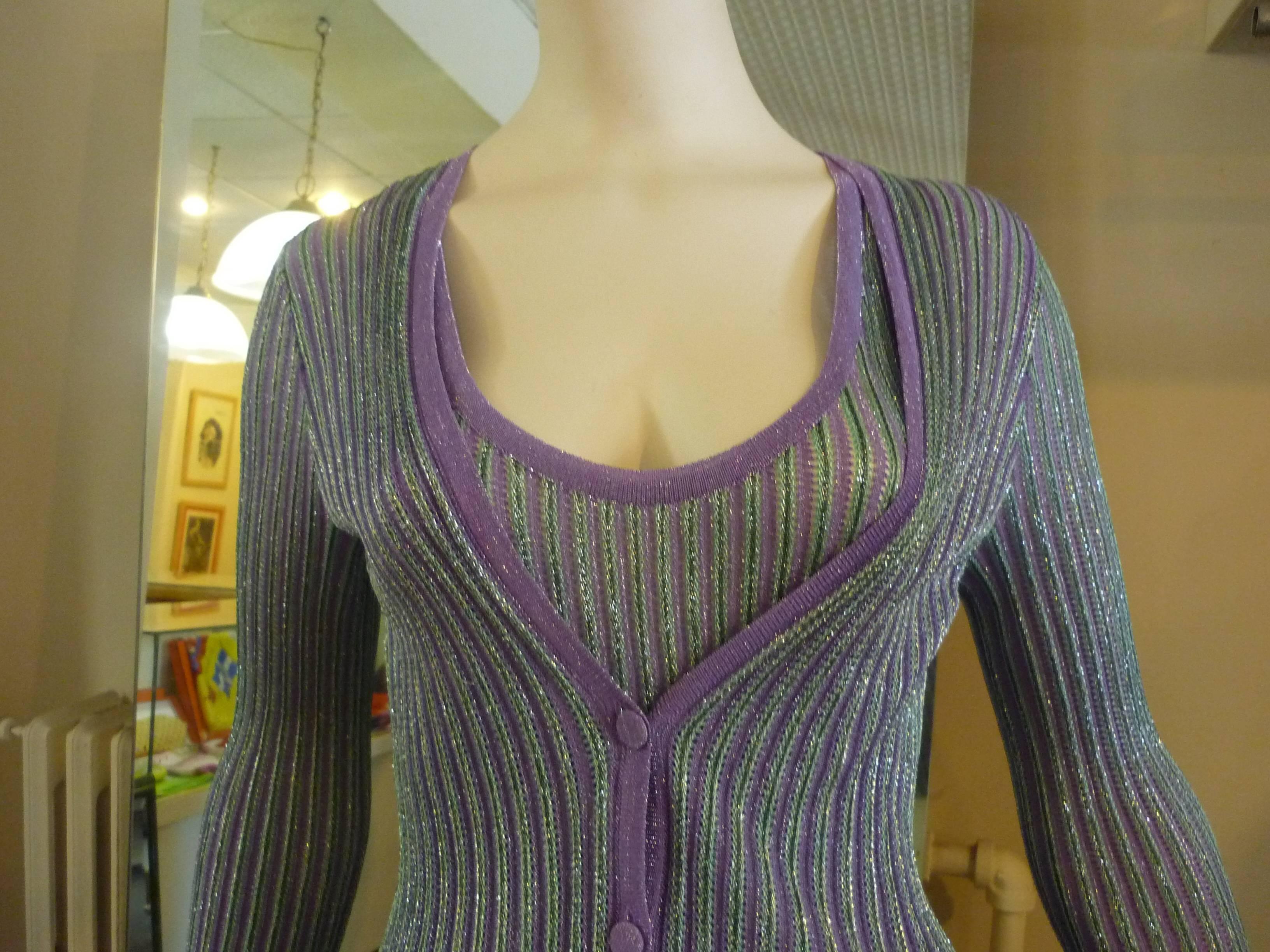 78% viscose and 22% nylon this lilac and green twin set is shot through with metal strands. The sleeveless top has a drawstring under the bust. The hems have a gondola effect, and closure for the cardigan is with covered buttons.