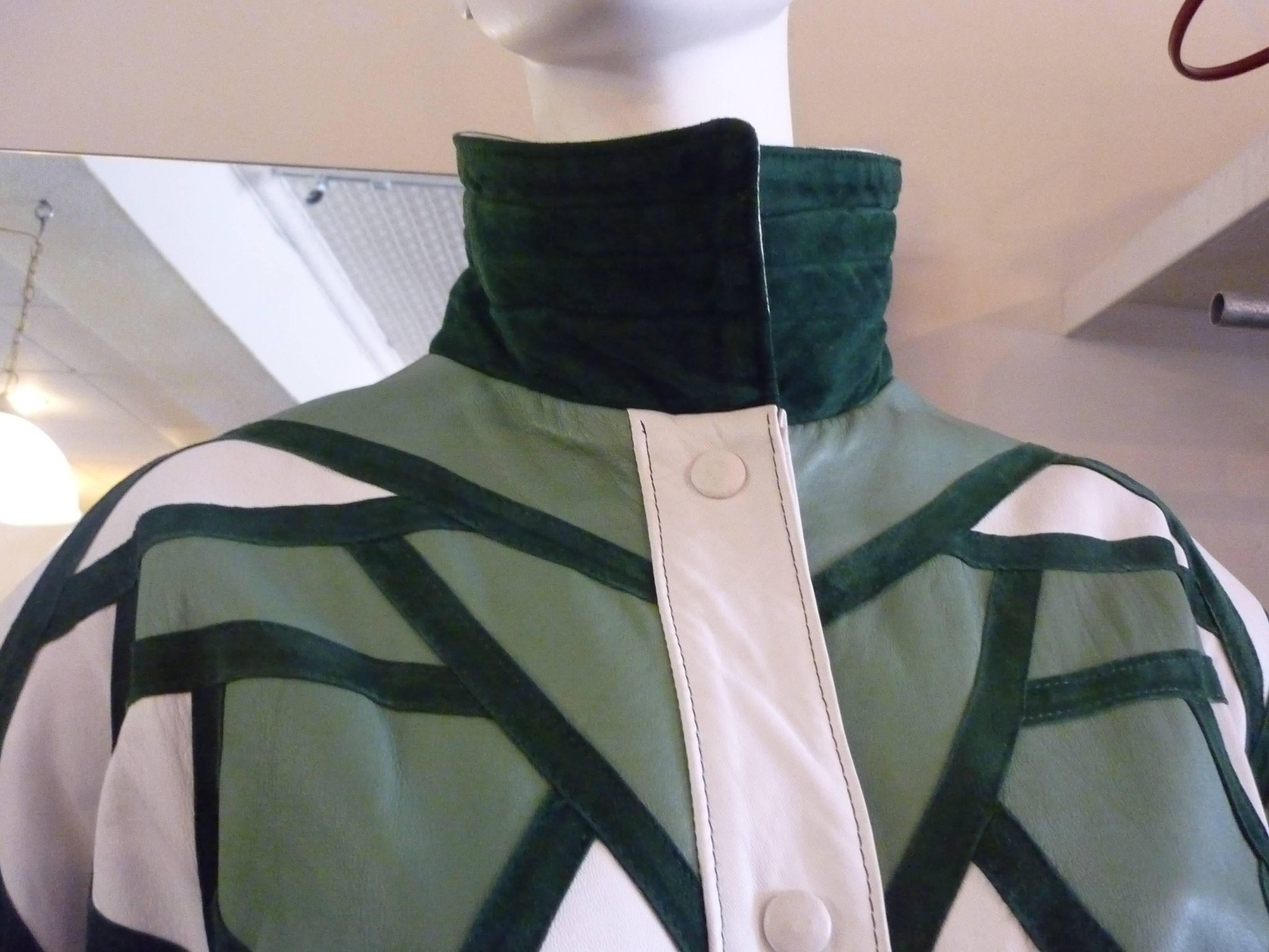 The lining is Yves Saint Laurent, but there is no label. It is a very nice jacket regardless, with snap button closure and a collar which when raised reveals green suede.

The colors are light green with darker green borders and a creamy