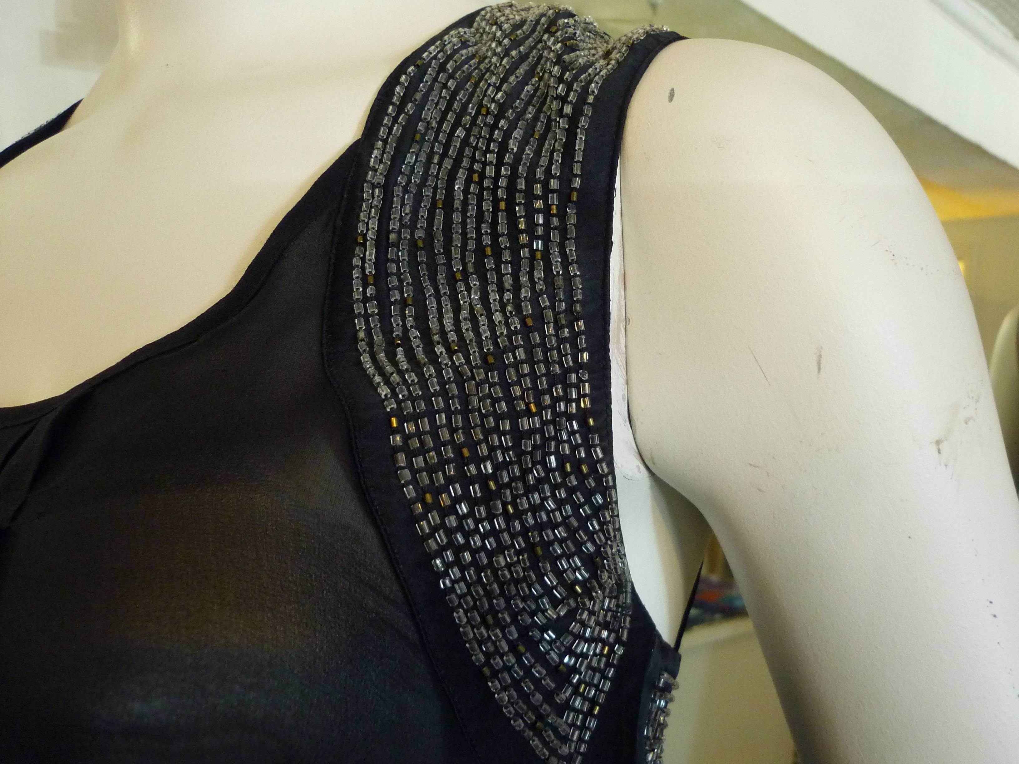 Beautiful top with bead embellishment on the front and back. There are also several pleats down the front. 