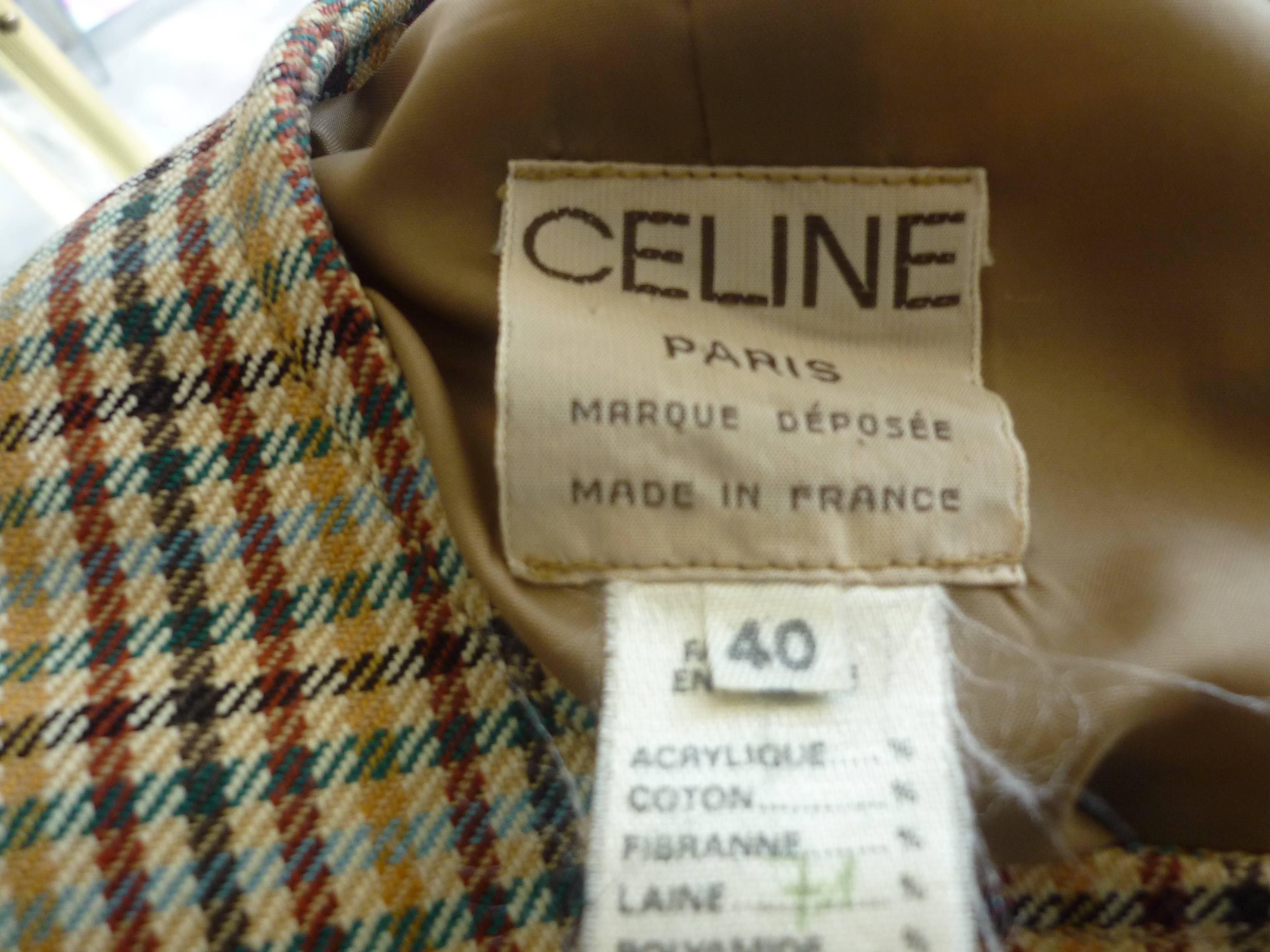 Nice two piece skirt suit by Celine with fine detailing. The suit jacket has a round neckline; four signed button closure and two smaller buttons on each cuff; there are belt loops but the original belt is missing, and I have replaced it with a