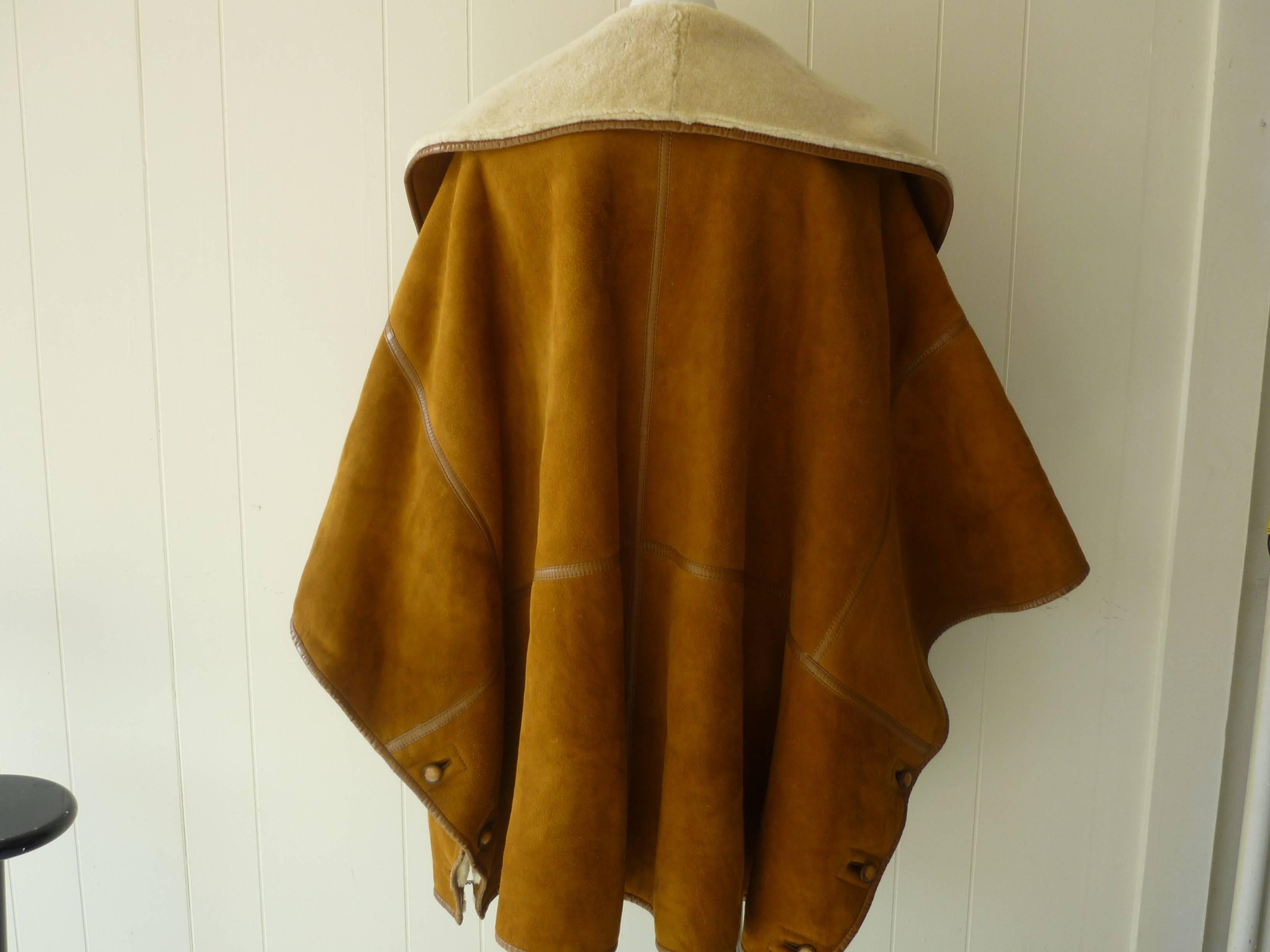 Beatifully tailored piece in excellent condition. The cape is fastened on both sides with buttons and chain; there are two deep pockets on the front, and double breasted button closure. Corners and buttons are all re-enforced, and the cape was made