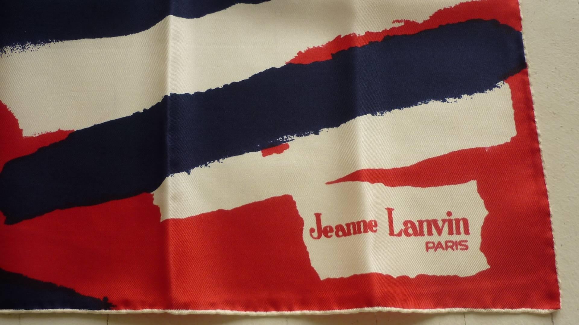 This is a scarf by one of the Grande Dame of couture. The red, white and blue, patriotic scarf is made of a heavy weight silk, and has nice and plump hand rolled edges.