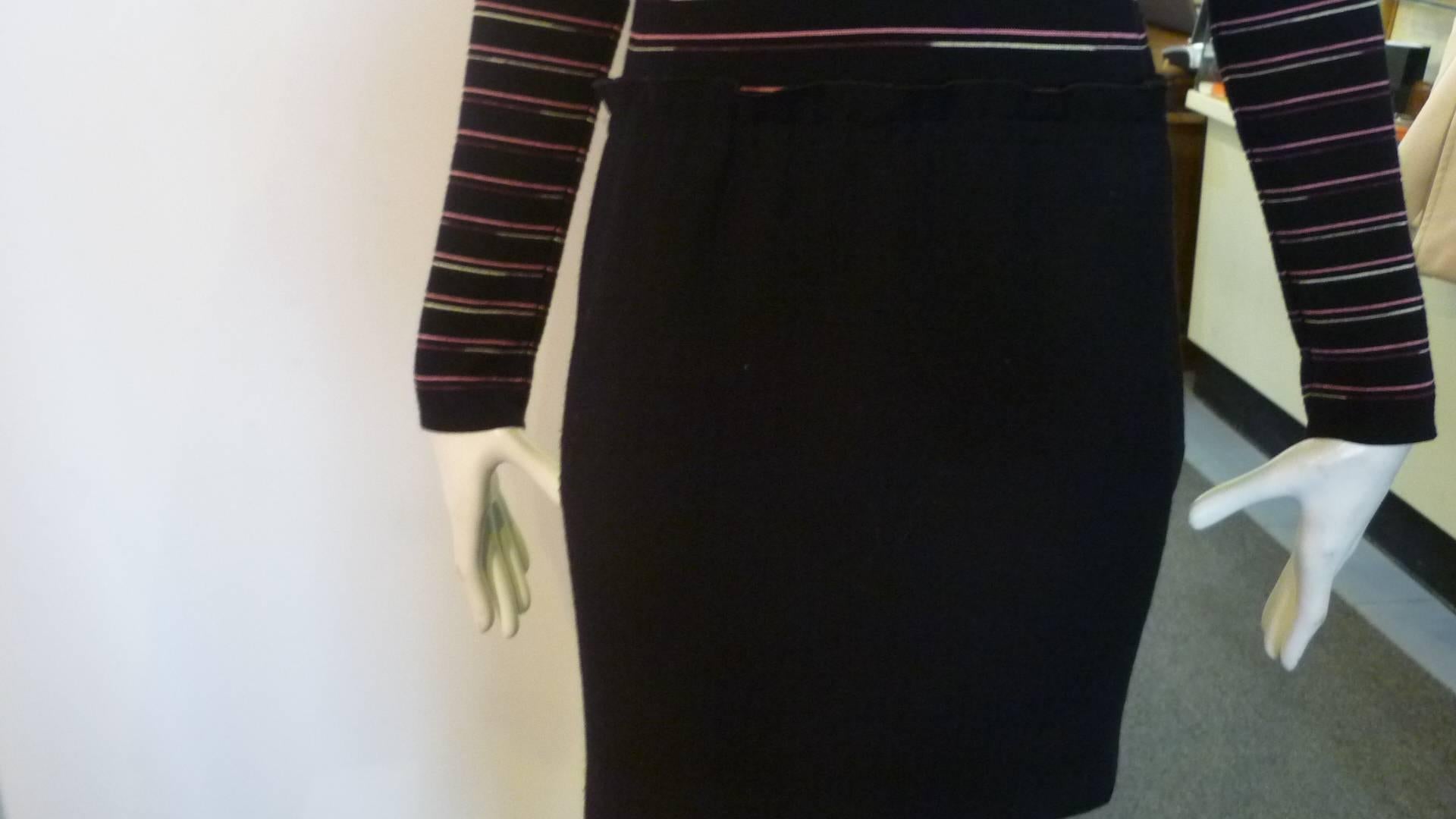 Horizontal striped top with a solid black skirt starting at the hip line with a soft gathered detail. The skirt has side slit pockets.

Zip closure at the side.