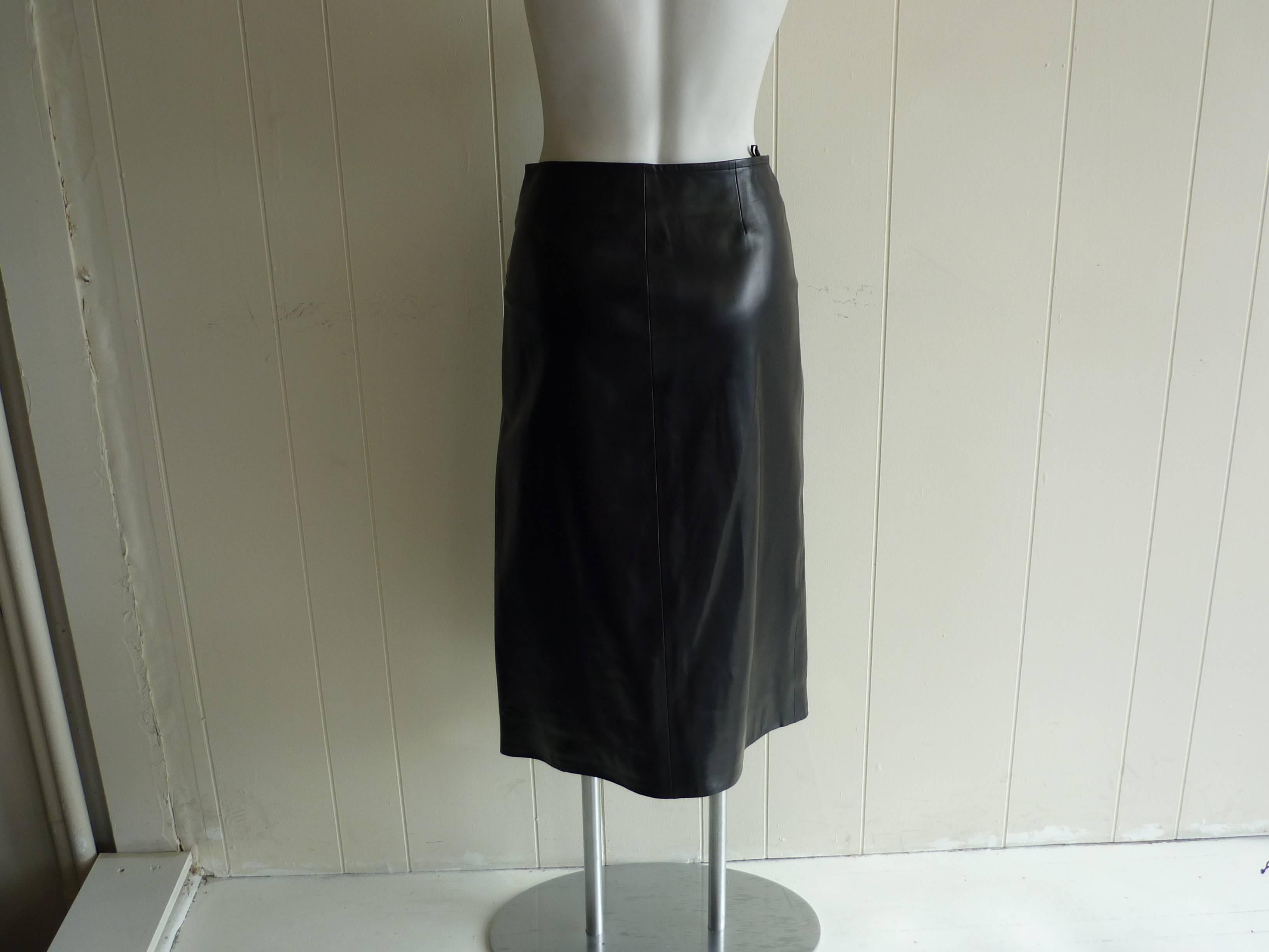 This butter soft lambskin wrap skirt has wonderful silver hardware fastening incised with the Celine logo.

The fit is slightly assymetrical, allowing the leg to peep out at the bottom.

This skirt was never worn.
