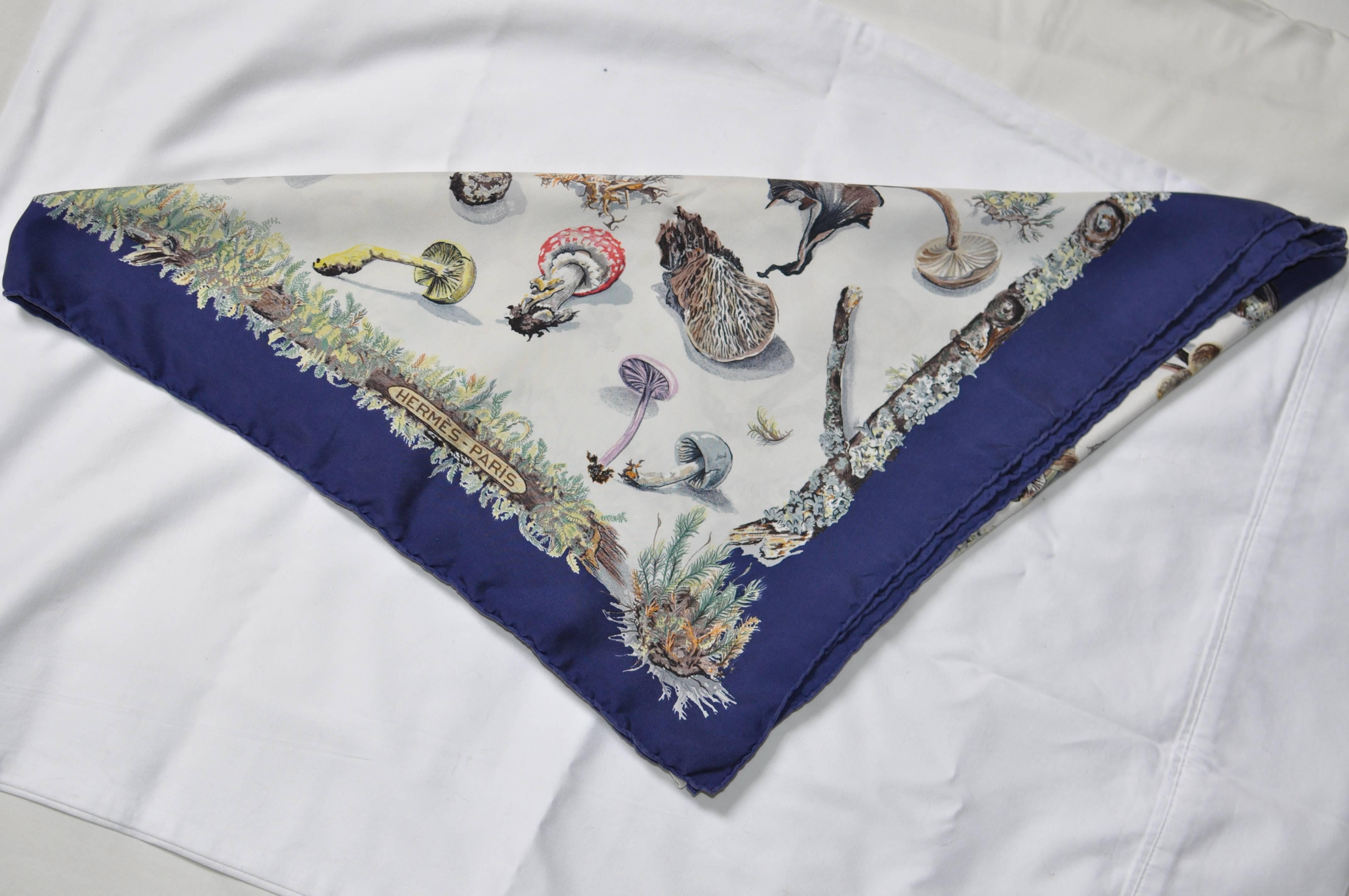 This scarf has a blue border with a variety of mushrooms depicted in various colors.

The 1st issue of this scarf designed by Anne Cavarni and Frncoise de la Perriere was in 1959 and the scarf was re-issued in 2005. I believe that this is the