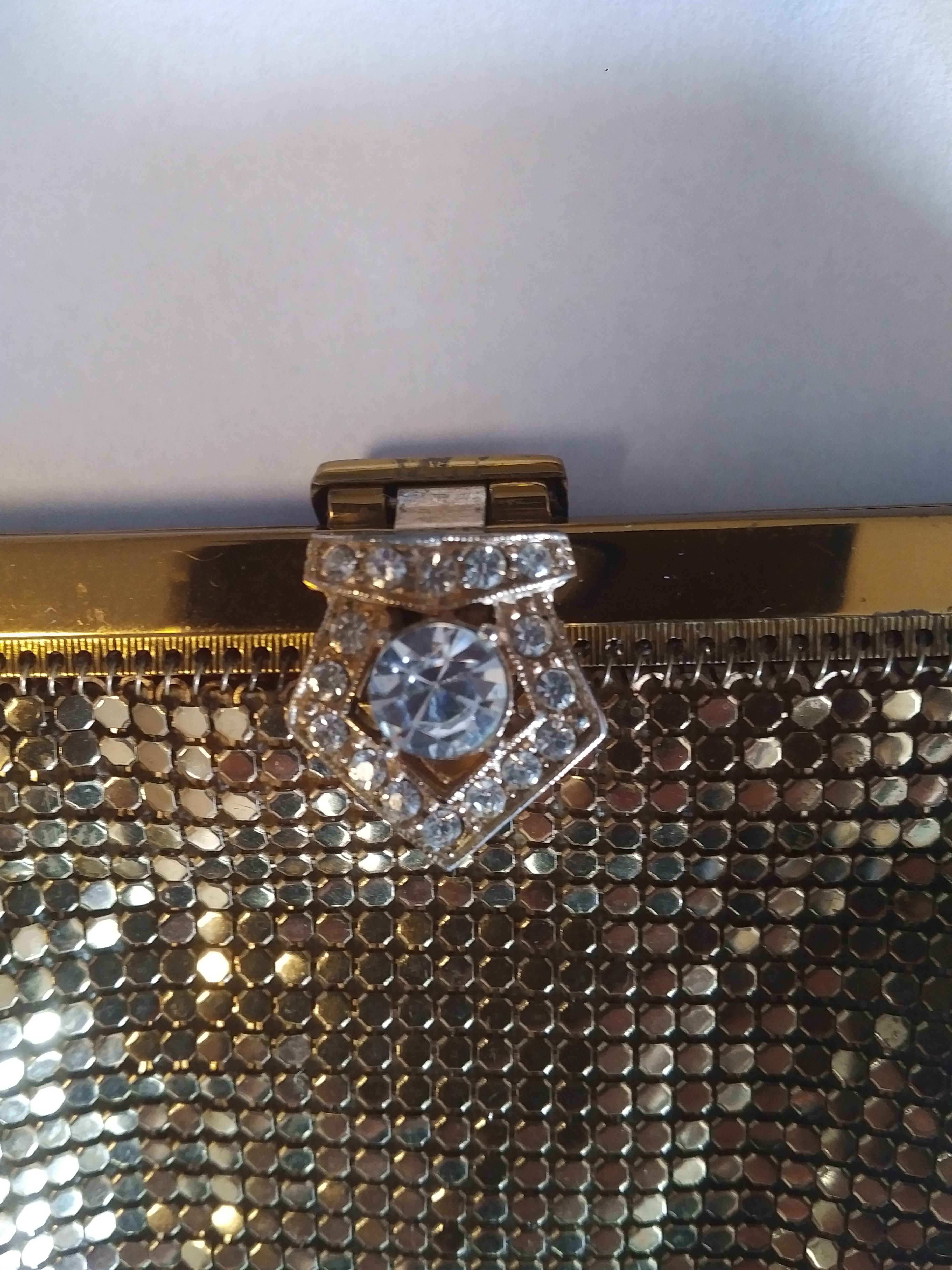 A duo of Whiting & Davis gold mesh coin purse and crystal rhinestone clasp clutch. Both have a peach satin lining, and the clutch is numbered 2978.

Coin purse measurements: 3.5