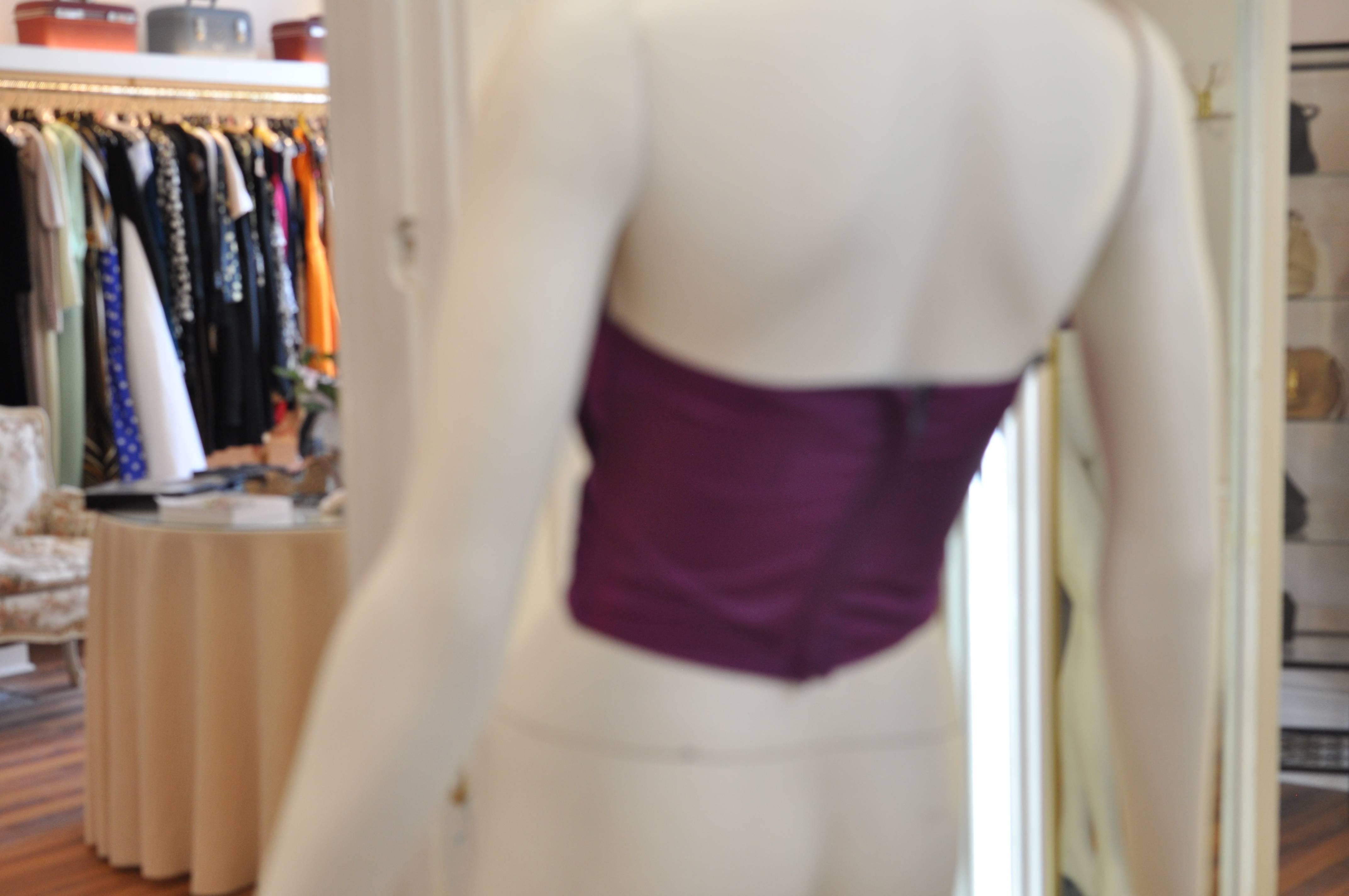This is an opportunity to own a vintage Zandra Rhodes at a good price! The acetate bustier is a lovely burgundy with a deep purple polyester lining, and is both pleated and ruffled.

there is discoloration through the front, but much of it blends in.