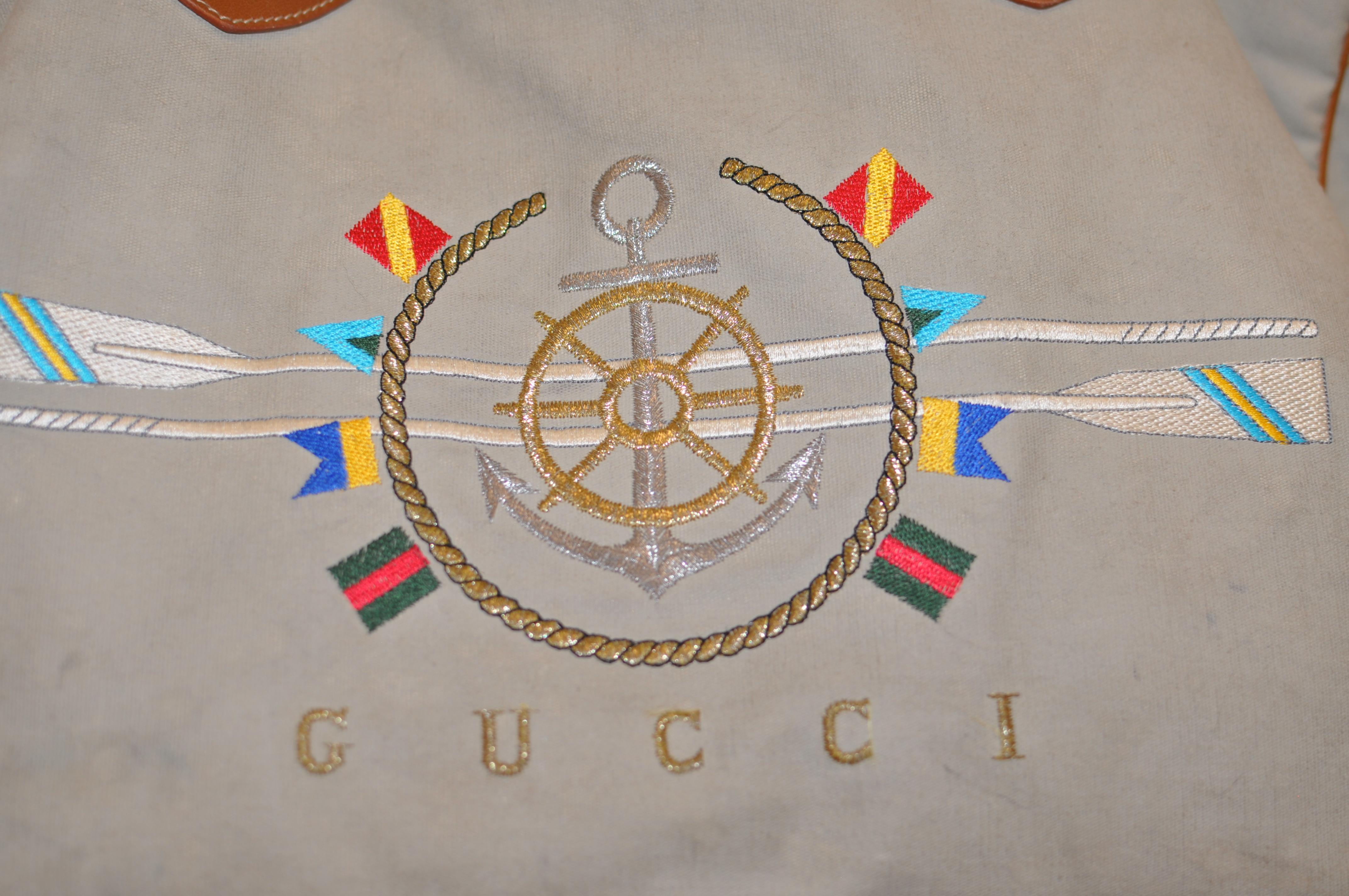 The handbag has two rope and leather handles; stripped blue and white cotton lining; an inside zipped pocket; snap closure at top, and colorful nautical designs. 

It has been marked fair as it needs a good cleaning and there is some wear to the